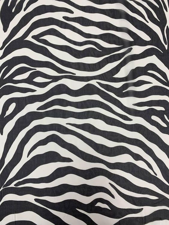 This bold zebra pattern printed silk chiffon designer fashion fabric in black and off-white is a strikingly adventurous animal print. SKU: 7912 Content: 100% Silk Color: Black / Off-White Width: 44 inches This fabric is a last cut and no longer in production. Once sold out, we are unable to get more.