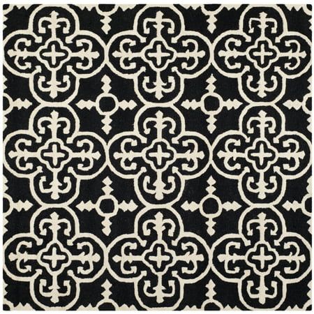 SAFAVIEH Cambridge CAM133E Handmade Black / Ivory Rug The Cambridge Collection brings modern American style to the home or office with this marvelous selection of hand-tufted wool area rugs. Cambridge rugs are beautifully styled with classic geometric patterns masterfully woven into plush cut piles and texture-rich high/ low loop and cut piles. Add all-Americana character and charm to home decor with Cambridge area rugs. Rug has an approximate thickness of 0.63 inches. For over 100 years, SAFAVI