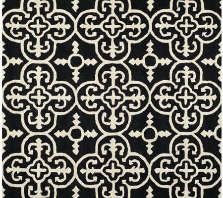 SAFAVIEH Cambridge CAM133E Handmade Black / Ivory Rug The Cambridge Collection brings modern American style to the home or office with this marvelous selection of hand-tufted wool area rugs. Cambridge rugs are beautifully styled with classic geometric patterns masterfully woven into plush cut piles and texture-rich high/ low loop and cut piles. Add all-Americana character and charm to home decor with Cambridge area rugs. Rug has an approximate thickness of 0.63 inches. For over 100 years, SAFAVI