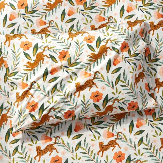 Big cats stalk gracefully amidst oversized plant life, stopping to smell all the prettiest flowers on our Marrakech Tiger Pillowcase. Illustrated in a modern palette of olive green, shades of teal and peachy pinks, the colorful jungle scene pops against the bright white background. Perfect for young adventurers, this organic cotton pillowcase cleans up easily in the washing machine. To complete the look, add the other bedding in our exclusive Marrakech Tiger collection.Pillowcase with tiger patt