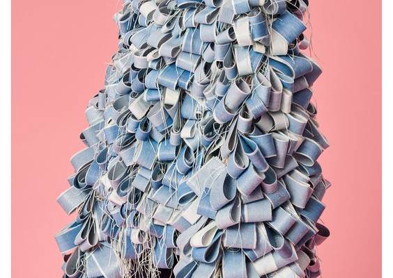 For her final graduate collection, Hannah initially looked towards the natural world for inspiration, focusing specifically at images of water that has been polluted by dye and ink waste of the textiles industry, as well as researching the effects that these environmental issues have on the surrounding communities. Hannah developed her colour palette from her own photographs of landscapes; these photographs also informed her yarn and fabric choices throughout the collection. The textural qual...