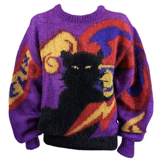Charming and collectable Krizia Felix black cat oversized signature pullover crewneck sweater in soft knit blend. “Felix” the cats name is knitted into right sleeve. 1980’s Italy. Size 42. Excellent Condition, Angora 20%.Mohair 70%,Polyester 10% Length 24″, Hem 26″ Shoulder 6″, Sleeve 26″