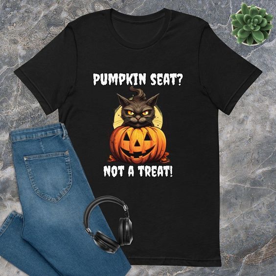 This grumpy cat has a message: ‘Pumpkin seat? Not a treat!’ 🎃🐱🙅‍♀️ Share the humor this Halloween with our unique shirt. Click to learn more and add a touch of feline mischief to your style! 👚