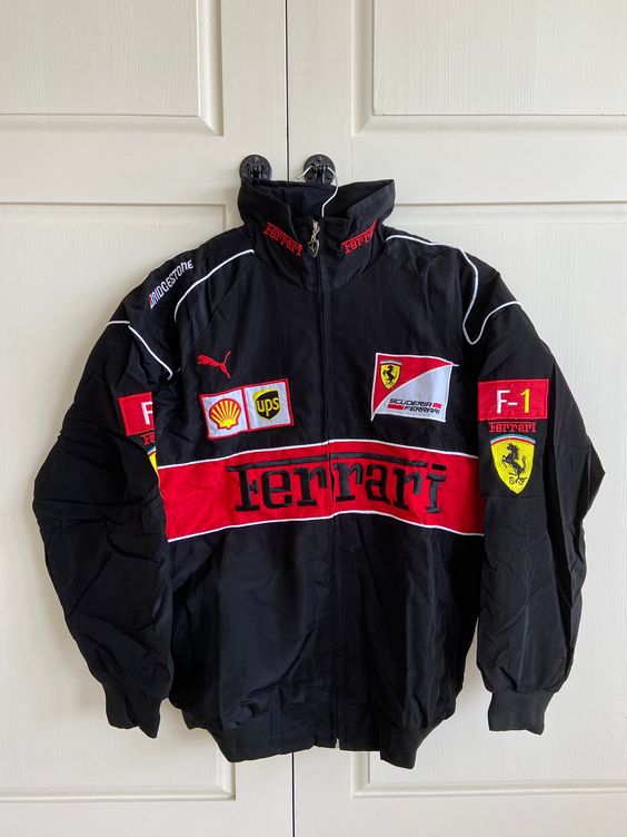Introducing the Vintage Black and Red Ferrari Racing/Bomber Jacket, the perfect addition to any motorsports enthusiast’s wardrobe. This jacket combines classic style with modern comfort, making it a must-have for any fashion-savvy car lover. Crafted from high-quality materials, this jacket features a sleek black and red design that pays homage to the iconic Ferrari racing team. The embroidered Ferrari logo on the front adds an extra touch to this already stunning piece. Available in sizes M, L,