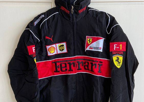 Introducing the Vintage Black and Red Ferrari Racing/Bomber Jacket, the perfect addition to any motorsports enthusiast's wardrobe. This jacket combines classic style with modern comfort, making it a must-have for any fashion-savvy car lover. Crafted from high-quality materials, this jacket features a sleek black and red design that pays homage to the iconic Ferrari racing team. The embroidered Ferrari logo on the front adds an extra touch to this already stunning piece. Available in sizes M, L,