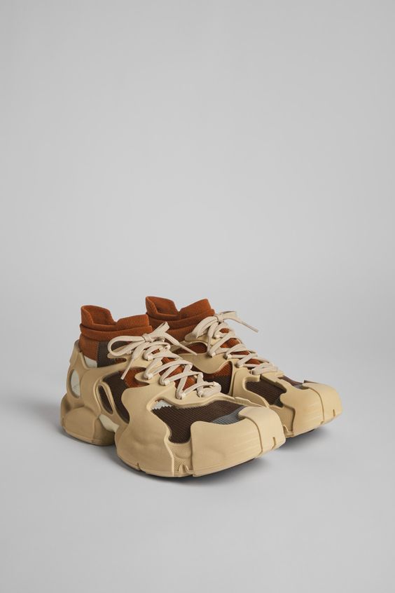 Brown caged sneakers with 3D-knitted water repellent sock interiors made from recycled PET, TPU exteriors, and 100% recycled PU outsoles. Fully recyclable.