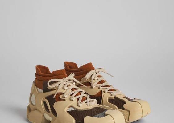 Brown caged sneakers with 3D-knitted water repellent sock interiors made from recycled PET, TPU exteriors, and 100% recycled PU outsoles. Fully recyclable.