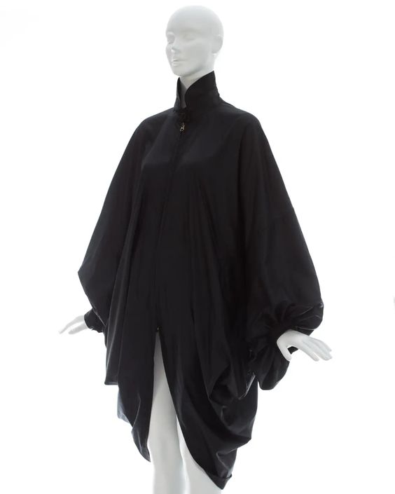 For Sale on 1stDibs – Issey Miyake; Black nylon oversized parachute coat with batwing sleeves and two front pockets Fall-Winter 1987