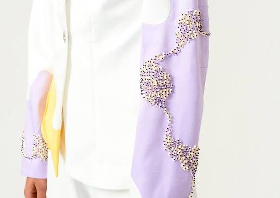 Ivory suit with hints of lilac and yellow is such a pleasant sight. This two-piece suit look has adorable details that stand out so subtly. It’s a must have for an elegant, chic and unique look. Shine in this ivory and lilac blazer stitched out in poly velvet satin. It features embroidery detail on sleeves, rope detail on yellow panel made out of banana crepe and a front button opening. This out of ordinary pair of ivory trousers stand out due to its interesting PU leather laser cut patch work.