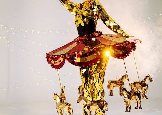 Carnival custom women's mirror carousel costume with moving gold horses is the ultimate show-stopper that will turn heads at any party or event. This unique costume features a mesmerizing skirt with a moving mechanism that rotates beautiful gold horses around the wearer, creating a stunning visual effect. Crafted from high-quality materials, the mirror costume is designed to fit comfortably and securely, ensuring that the wearer can dance and move. The intricate details of the costume are sure t