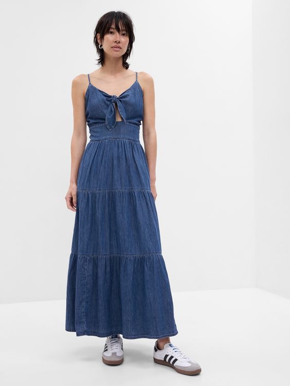Soft cotton denim maxi dress.  V-neck.  Sleeveless.  Spaghetti straps.  Self-tie and cutout at front.  This denim dress is part of our water-saving Washwell program.  Compared to conventional wash methods, Washwell has saved millions of liters of water since 2016.  Fitted through the chest with a relaxed A-line silhouette.  Hits above the ankle.  Models wearing Gap