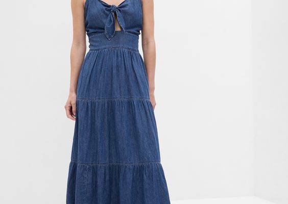 Soft cotton denim maxi dress.  V-neck.  Sleeveless.  Spaghetti straps.  Self-tie and cutout at front.  This denim dress is part of our water-saving Washwell program.  Compared to conventional wash methods, Washwell has saved millions of liters of water since 2016.  Fitted through the chest with a relaxed A-line silhouette.  Hits above the ankle.  Models wearing Gap
