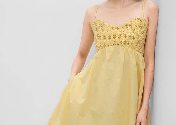 Soft mixed cotton mini dress with pockets.  Sweetheart neckline.  Sleeveless.  Spaghetti straps.  Eyelet bodice with a soft cotton skirt.  Front slant pockets.  Smocked back.  A-line silhouette with a relaxed fit.  Hits above the knee.  Models wearing Gap