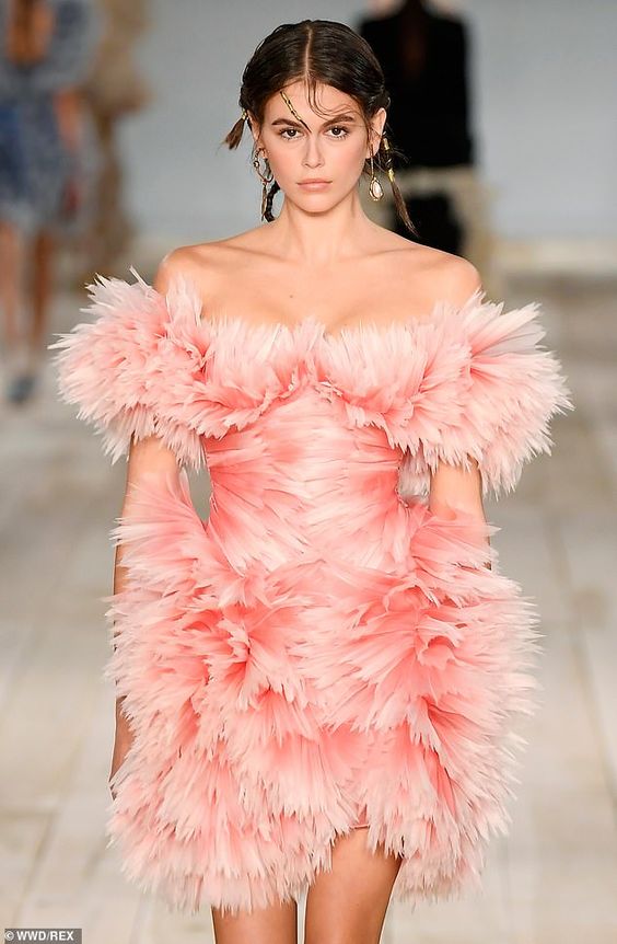 Kaia Gerber commands attention in a dramatic pink featured dress at Alexander McQueen’s PFW show