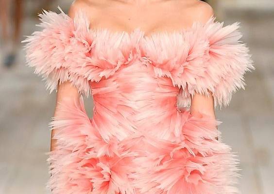 Kaia Gerber commands attention in a dramatic pink featured dress at Alexander McQueen's PFW show