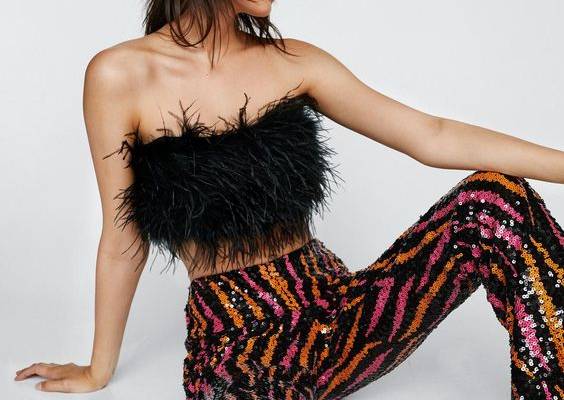 Turn up the heat. Team with a feather crop top and chunky sandals for a night to remember. Sequin Flame Kick Flared Pants Fit and Flare Pants Pull-On Style Long Length All-Over Sequin Embellishments Flame Design Comfortable Woven Lining Model wears size M (US size 6/UK size 10).