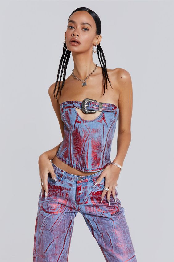 Elevate your look with the Midtown Metallic Corset. Featuring a belt buckle, angled panel seams with boning and designed in a cropped fit. This style boasts a classic bardot shape crafted with blue and red distressed foil technique. Effortlessly complete the look with the matching jeans.
