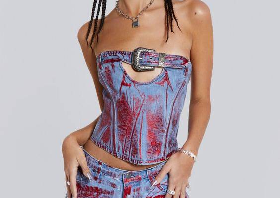 Elevate your look with the Midtown Metallic Corset. Featuring a belt buckle, angled panel seams with boning and designed in a cropped fit. This style boasts a classic bardot shape crafted with blue and red distressed foil technique. Effortlessly complete the look with the matching jeans.